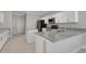 Modern kitchen with white cabinets, granite countertops and stainless steel appliances at 7900 Saint Giles Pl, Orlando, FL 32835