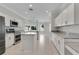 Modern kitchen with white cabinets, granite countertops, stainless steel appliances and center island at 7900 Saint Giles Pl, Orlando, FL 32835