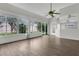 Bright sunroom with vaulted ceiling, a ceiling fan, and large windows overlooking the backyard at 7900 Saint Giles Pl, Orlando, FL 32835
