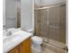 Bathroom with glass shower, tiled walls, toilet, mirror, and vanity at 84 Camino Real Blvd, Howey In The Hills, FL 34737