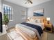 Cozy bedroom with a king bed, large windows, a ceiling fan and soft, natural light at 84 Camino Real Blvd, Howey In The Hills, FL 34737