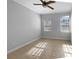 Bedroom with fan, tile floor, white walls, baseboard trim, and window at 84 Camino Real Blvd, Howey In The Hills, FL 34737