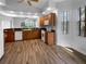Charming kitchen featuring wood cabinets, stainless steel appliances, and hard wood floors at 84 Camino Real Blvd, Howey In The Hills, FL 34737