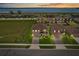 Beautiful aerial view of a neighborhood with a serene lake backdrop and colorful sunset at 850 Lazio Cir, Debary, FL 32713