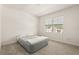 Comfortable bedroom with soft carpet, a cozy gray bed, and natural light streaming through the window at 850 Lazio Cir, Debary, FL 32713