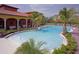 A view of the community pool including lounge chairs, fountains, and palm trees at 850 Lazio Cir, Debary, FL 32713