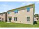 A view of the back of the property showcasing neutral colored walls and expansive green lawn at 850 Lazio Cir, Debary, FL 32713