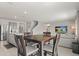 Living room with an adjacent dining area and kitchen; perfect for modern living at 850 Lazio Cir, Debary, FL 32713