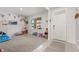 Spacious living room with neutral carpet and colorful wall decorations, filled with toys at 850 Lazio Cir, Debary, FL 32713