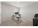Minimalist office features a modern desk setup, neutral walls, and soft carpet for a productive workspace at 850 Lazio Cir, Debary, FL 32713