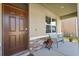 Inviting front porch with a cozy seating area and decorative brick accents at 850 Lazio Cir, Debary, FL 32713