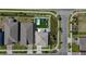 Overhead view of the home and backyard featuring a pool, artificial turf and patio at 9027 Coral Cape St, Kissimmee, FL 34747