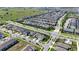 Wide aerial view of a planned community highlighting the harmonious blend of homes, streets, and lush greenery at 9027 Coral Cape St, Kissimmee, FL 34747