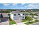 Aerial view showcasing a home with a private pool, a detached garage and a meticulously landscaped front yard at 9027 Coral Cape St, Kissimmee, FL 34747