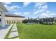 Spacious backyard with artificial turf, fenced pool, and trampoline, perfect for outdoor activities at 9027 Coral Cape St, Kissimmee, FL 34747