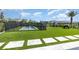 Well-maintained backyard with artificial turf, fenced pool, rock climbing and play area at 9027 Coral Cape St, Kissimmee, FL 34747