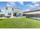 Beautiful backyard featuring artificial turf, a fenced pool, and outdoor seating area at 9027 Coral Cape St, Kissimmee, FL 34747