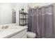 Neutral bathroom with a large mirror and shelving at 9027 Coral Cape St, Kissimmee, FL 34747