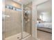 Tiled walk-in shower with glass door at 9027 Coral Cape St, Kissimmee, FL 34747