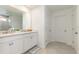 Modern bathroom featuring double sinks, white cabinetry, and tile flooring at 9027 Coral Cape St, Kissimmee, FL 34747