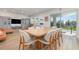 Light and airy dining room featuring modern furniture and natural light. The dining room is part of an open concept living area at 9027 Coral Cape St, Kissimmee, FL 34747