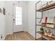 Bright entryway featuring wood floors, a stylish console table with decorative items, and a paneled front door at 9027 Coral Cape St, Kissimmee, FL 34747