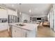 Open-concept kitchen with stainless steel appliances that flows into the dining and living areas at 9027 Coral Cape St, Kissimmee, FL 34747