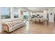 Bright living area showcasing a large couch next to the dining room and kitchen at 9027 Coral Cape St, Kissimmee, FL 34747