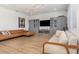 Open-concept living area showcasing an L-shaped couch with gray cabinetry at 9027 Coral Cape St, Kissimmee, FL 34747