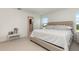 Spacious main bedroom showcasing a plush bed, neutral decor, and an ensuite bathroom at 9027 Coral Cape St, Kissimmee, FL 34747