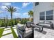 Outdoor patio featuring modern seating, pavers, and tropical landscaping at 9027 Coral Cape St, Kissimmee, FL 34747