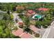 Community aerial view features red tile roofs, mature trees, community pool, and gated entrance at 935 Northern Dancer Way # 107, Casselberry, FL 32707