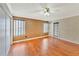 Bedroom featuring wood laminate flooring, neutral paint and multiple windows for natural light at 935 Northern Dancer Way # 107, Casselberry, FL 32707