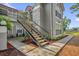 Condo exterior with landscaped stair access featuring mulched flower beds and manicured plantings at 935 Northern Dancer Way # 107, Casselberry, FL 32707