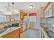 Well-lit kitchen with modern black sink and mosaic tile backsplash at 935 Northern Dancer Way # 107, Casselberry, FL 32707