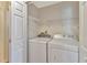 Bright laundry room featuring a modern white washer and dryer set and wire shelving at 935 Northern Dancer Way # 107, Casselberry, FL 32707