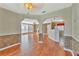 Open-concept living space with hardwood floors, seamlessly connecting living room and kitchen area at 935 Northern Dancer Way # 107, Casselberry, FL 32707
