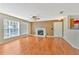 Bright living room showcasing wood floors, fireplace and neutral paint at 935 Northern Dancer Way # 107, Casselberry, FL 32707