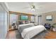 Stylish main bedroom featuring a calming color palette, ample windows, and wood laminate flooring at 935 Northern Dancer Way # 107, Casselberry, FL 32707