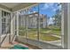 View from the screened-in patio showcasing the well-maintained lawn and the building's exterior at 935 Northern Dancer Way # 107, Casselberry, FL 32707