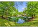 Scenic view of a tranquil pond reflecting the surrounding trees and sky at 935 Northern Dancer Way # 107, Casselberry, FL 32707
