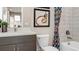Well-lit bathroom featuring a modern vanity, stylish mirror, and decorative shower curtain at 944 Club Cresswind Dr, Lady Lake, FL 32159