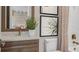 Bathroom vanity with white countertops, stylish fixtures, palm-themed artwork and a toilet at 944 Club Cresswind Dr, Lady Lake, FL 32159