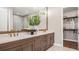 A modern bathroom with double vanity, quartz counters, stylish fixtures, and a spacious walk-in closet at 944 Club Cresswind Dr, Lady Lake, FL 32159