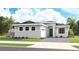 Charming single-story home featuring a brick paved driveway, manicured lawn, and tropical landscaping at 944 Club Cresswind Dr, Lady Lake, FL 32159