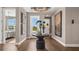 Grand foyer featuring hardwood floors, stylish decor, and a view into a bedroom at 944 Club Cresswind Dr, Lady Lake, FL 32159