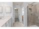 This bathroom offers a granite countertop with access to the walk-in closet and glass-enclosed shower at 10148 Hadley St, Orlando, FL 32829