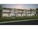 Charming townhome showcases neutral siding, a well-manicured lawn, and lush landscaping enhancing its curb appeal at 10148 Hadley St, Orlando, FL 32829