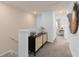 Hallway featuring black and natural woven cabinet with stairs to the lower level at 10148 Hadley St, Orlando, FL 32829