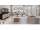 Bright living room featuring neutral furniture, stylish rug, and large windows for abundant natural light at 10148 Hadley St, Orlando, FL 32829